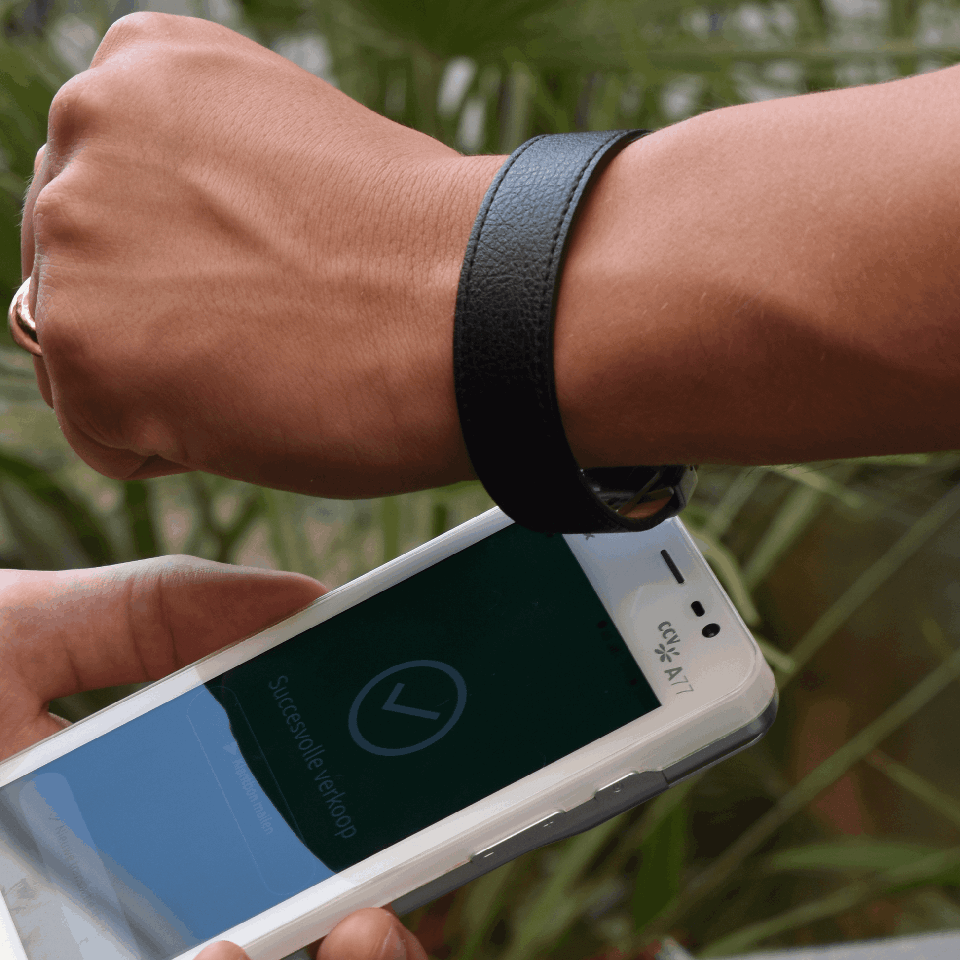 Astari x Bybit payment bracelet enabling contactless transactions with a smartphone, showcasing sustainable apple leather design.