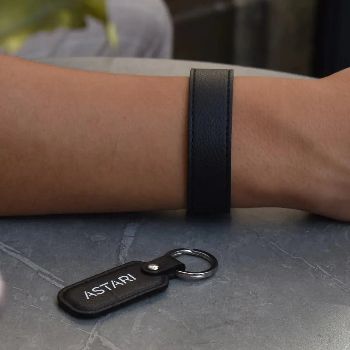 Astari x Bybit contactless payment bracelet on wrist, showcasing sustainable apple leather and stylish design.