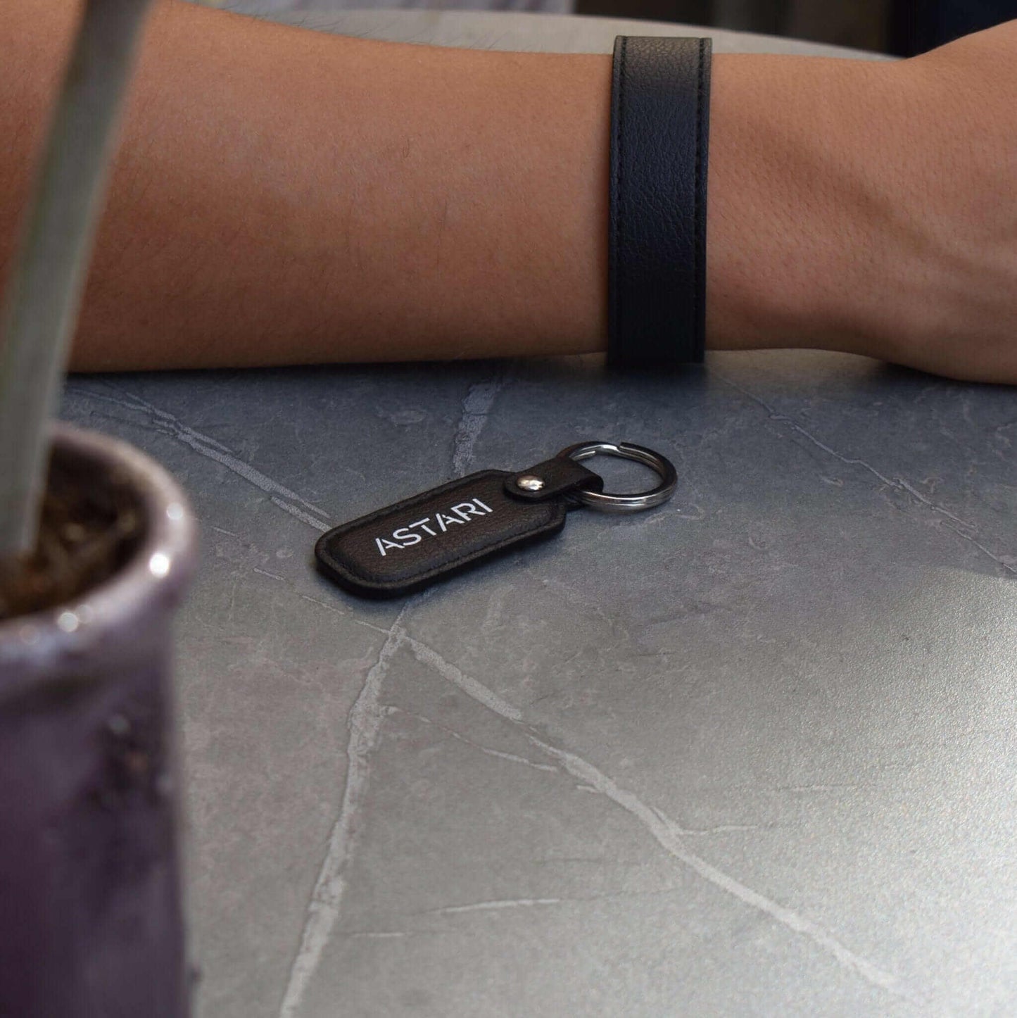 Person wearing contactless payment with sustainable Astari achilles payment keychain wearable